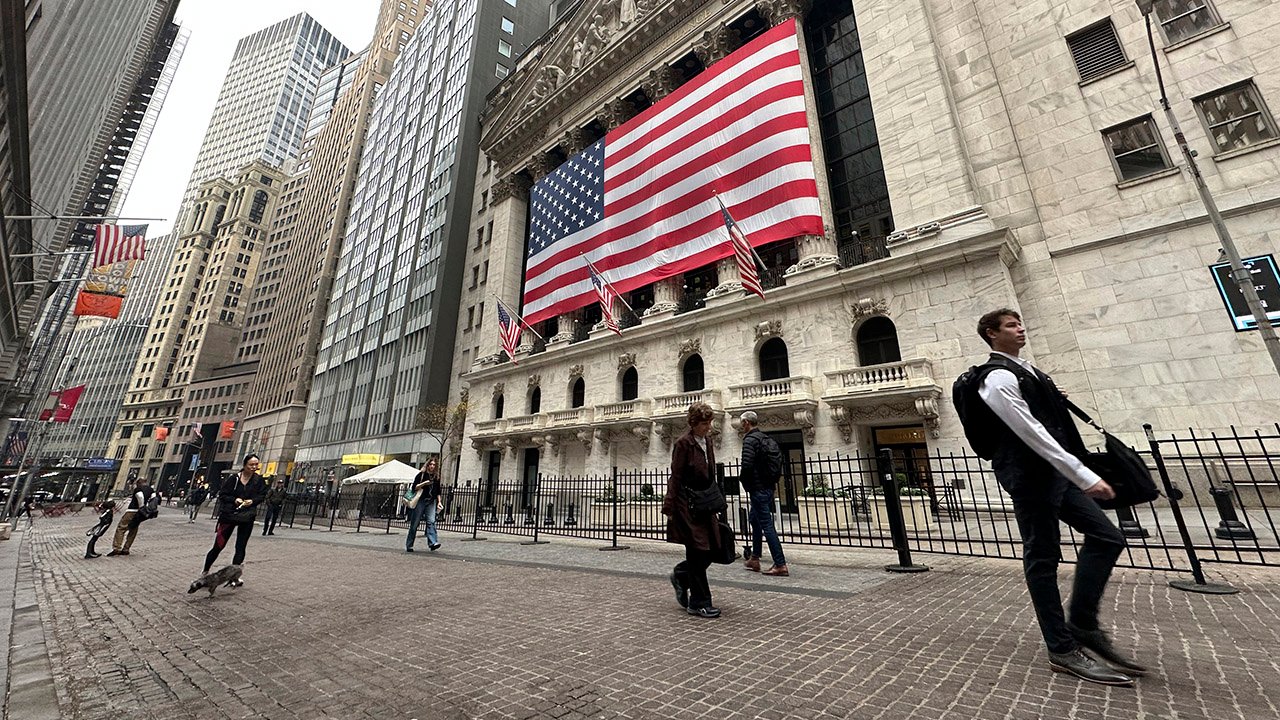 People pass the New York Stock Exchange in New York's Financial District on Tuesday, Nov. 5, 2024. (AP/Peter Morgan)