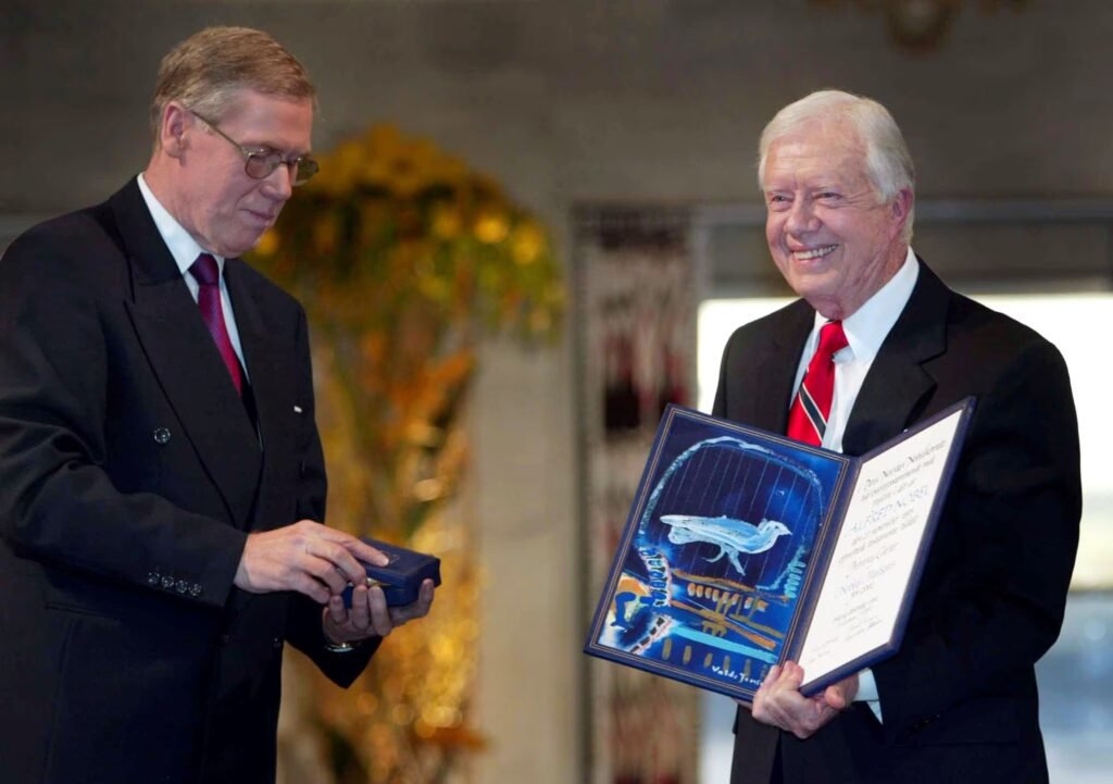 Former U.S. President Jimmy Carter receives his Nobel Peace Prize December 10, 2002 from chairman of the Norwegian Nobel Committee Gunar Berge (L) for decades of work for peace democracy and human rights from the Middle East to Haiti