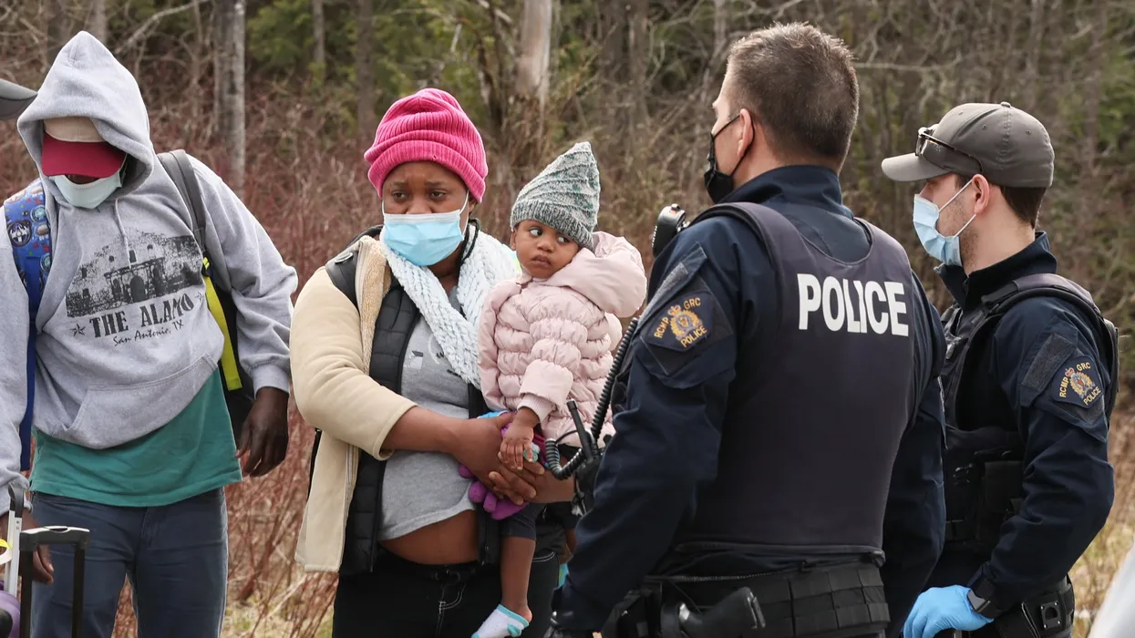 Asylum seekers cross into Canada from the U.S. border