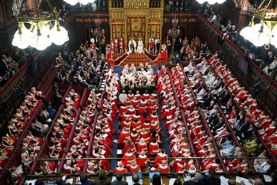 Britain's King Charles III sits besides Queen Camilla during the State Opening of Parliament at the Palace of Westminster in London.